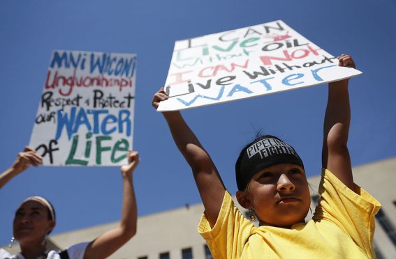 WASHINGTON, DC - AUGUST 24: Seven-year-old Omaka Nawicakinciji (R) of the Oglala Lakota Nation in South Dakota participates with his mother Heather Mendoza (L) during a rally on Dakota Access Pipeline August 24, 2016 outside U.S. District Court in Washington, DC. Activists held a rally in support of a lawsuit against the Army Corps of Engineers "to protect water and land from the Dakota Access Pipeline," and to call for "a full halt to all construction activities and repeal of all pipeline permits until formal tribal consultation and environmental review are conducted." (Photo by Alex Wong/Getty Images)
